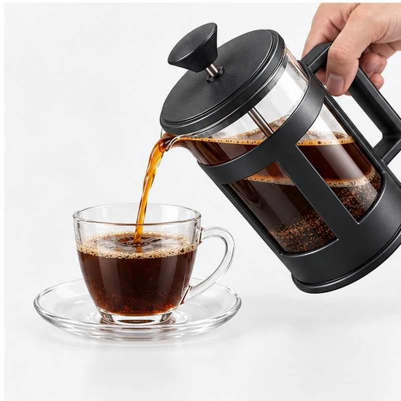 Café preparado en prensa francesa sirviéndose en una taza de vidrio.